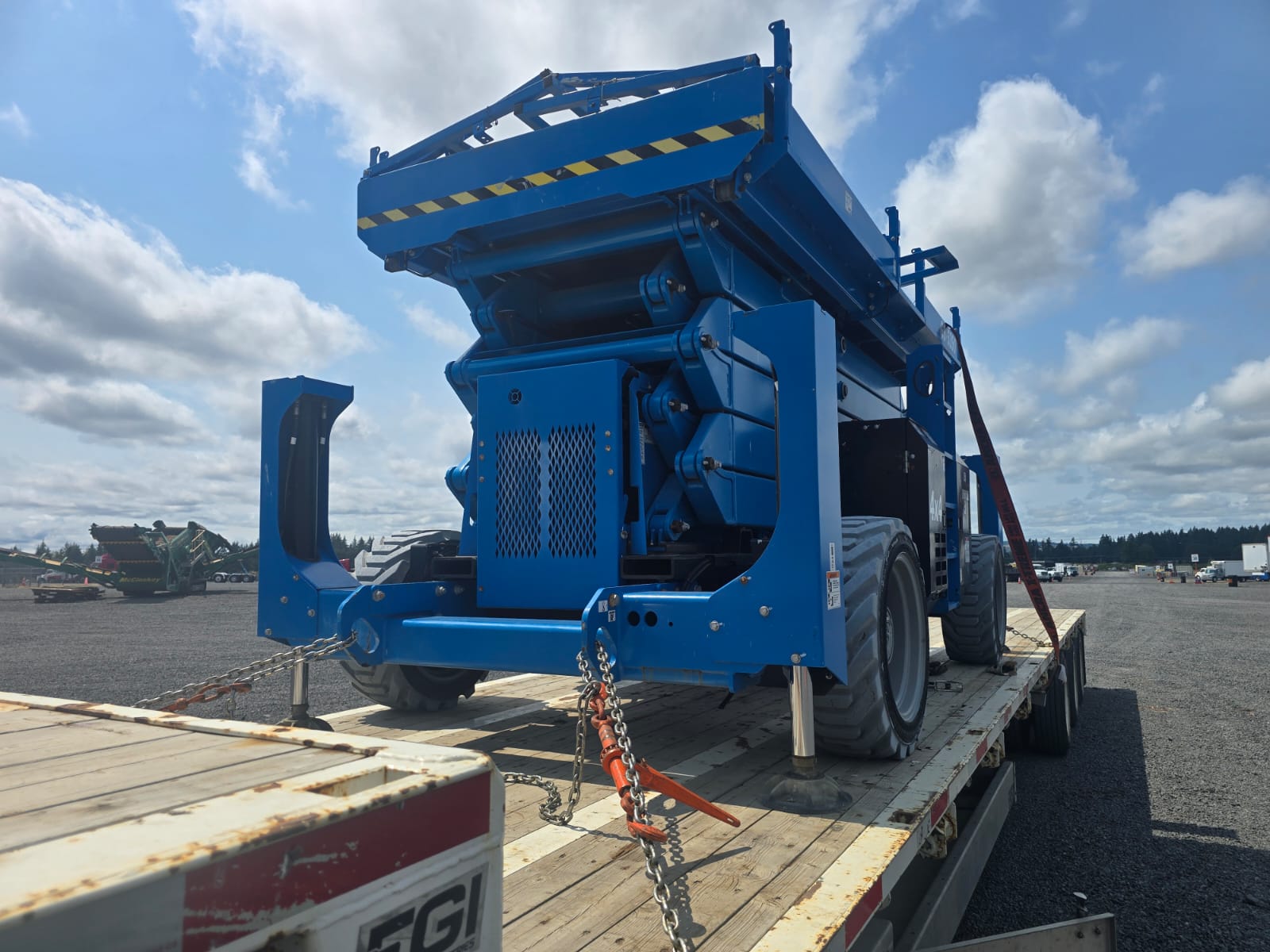 Scissor lift secured and chained for transport