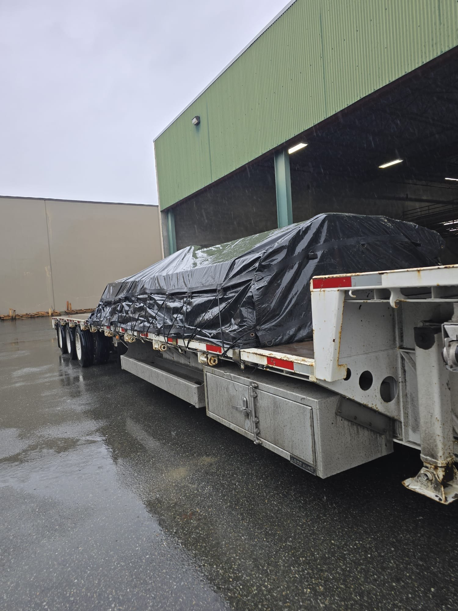 Tarped flatbed load in rain